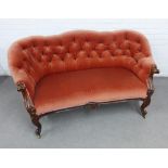 Victorian rosewood framed settee with button back upholstery, on carved cabriole legs with brass