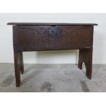 Antique oak bible box with carved front and iron lock plate, on trestle side supports, (old worm) 66