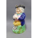 Staffordshire Toby jug, typically dressed and modelled seated with a frothing jug of ale, 24cm high