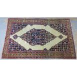 Persian rug, indigo and ivory field with foliate pattern and flowerhead border, 214 x 132cm