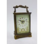 French brass cased carriage clock, the dial with Roman numerals and floral pattern, 15cm including