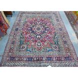 Persian carpet / rug, red field with central ivory medallion and foliate pattern with multiple