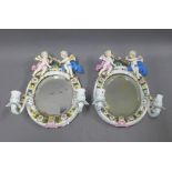 A pair of Dresden porcelain mirror back wall applique, with flowers and cherubs, blue AR backstamp