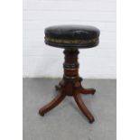 Victorian adjustable piano stool with a circular upholstered seat on a mahogany column with
