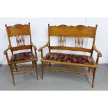 Arts & Crafts oak double chair back settee with carved serpentine top rail above spindles, with