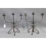 A pair of wrought iron three branch candelabra, 33cm (2)