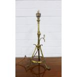Arts & Crafts brass lamp, in the manner of Benson, with adjustable arm and three outswept legs,