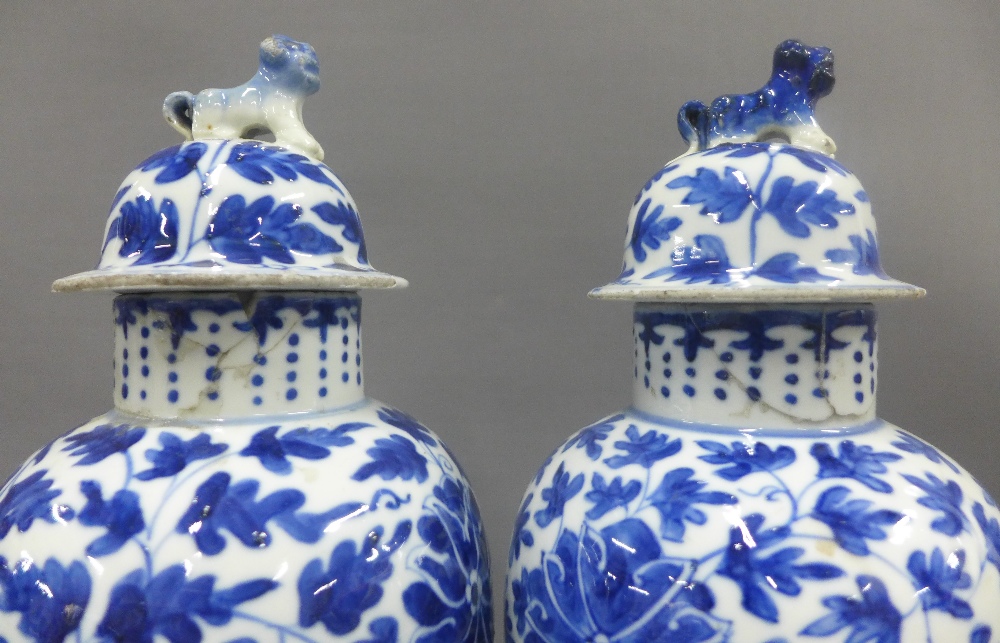 Pair of Chinese blue and white high shouldered baluster vases, covers with dog finials, painted - Image 3 of 4