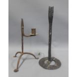 Antique iron rush light holder on tripod legs, 25.5cm, together with another (2)