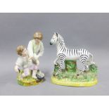 Staffordshire pottery Zebra and a group of two fighting boys, tallest 13cm ( (a/f) (2)