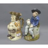 An American Sailor Toby jug, modelled seated upon a sea chest inscribed 'Dollars' and holding a