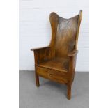 Antique elm wing back lambing chair with a good patination, with a solid seat over a drawer to the