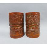 Pair of carved bamboo brush pots depicting a river scene with boat and figures, 12cm (2)