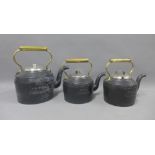 Three Holcroft iron kettles with brass handles to include 10 pints and two 5 pints, (3)