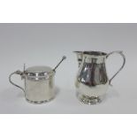 George V silver cream jug, London 1916, 9cm high and a silver plated mustard with blue glass liner
