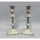 A pair of George V silver candlesticks, Hawksworth, Eyre & Co, Sheffield 1915, the bases with an