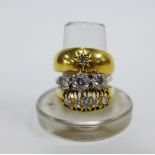 Three 18ct gold rings to include a three stone diamond ring, a Gypsy style diamond ring and