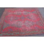 Turkish carpet, red field, worn and split mostly to centre, 457 x 354cm (a/f)