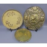 Brass wall plaque, circular brass tray with four claw feet and a circular wooden tray with dragon