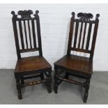 Pair of dark oak hall chairs, likely 17th century, with scroll carved cresting over vertical splat