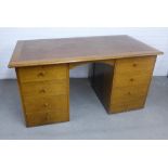 Early 20th century oak pedestal desk, rectangular top with faux leather skivver over an
