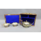 George V silver three piece teaset by George Edwards & Sons, Chester 1911, housed in an oak box with