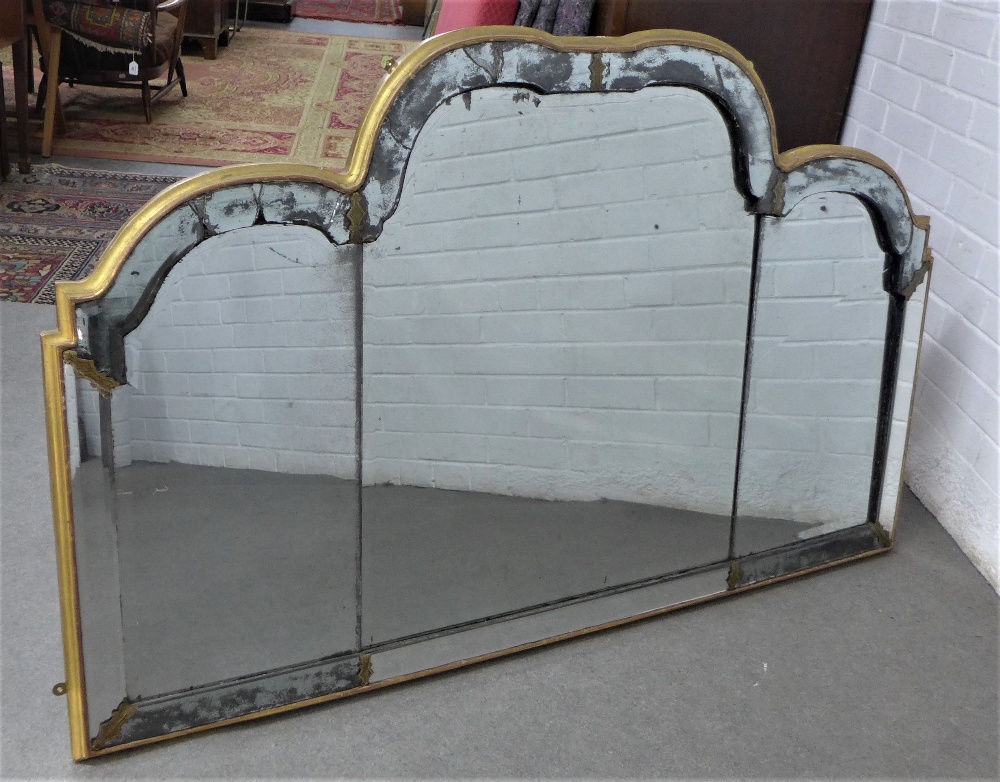 Giltwood triple plate wall mirror of scalloped form, within a bevelled and distressed border with