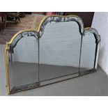 Giltwood triple plate wall mirror of scalloped form, within a bevelled and distressed border with