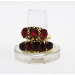 9ct gold garnet dress ring together with a 9ct gold three stone garnet ring (2)