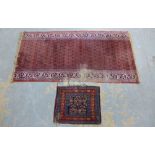 Persian boteh rug, with worn field and frayed edges 182 x 95cm, together with a small mat 60 x 50cm.