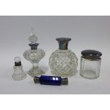 Three silver mounted and glass scent bottles, a silver topped glass dressing table jar and a blue