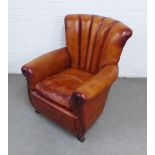 Art deco style brown leather club armchair with fan back, curved arms and brass stud piping, 79 x 88