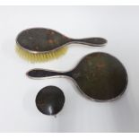 George V silver and tortoiseshell dressing table part set comprising hand mirror, hair brush and