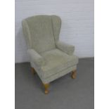 Modern upholstered wing arm chair on light oak cabriole legs, 70 x 105 x 50