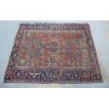 North West Persian rug, rust field with three blue medallions and multiple borders, 190 x 147cm