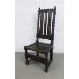 Dark oak chair with scroll carved top rail and back between spiral uprights, solid seat, the front