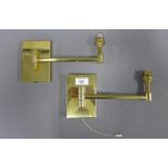 A pair of modern brass wall lights with swing action arms, length 22cm (2)