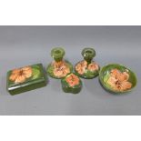 Collection of green glazed Moorcroft pottery to include a pair of candlesticks, 9cm high,