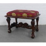 Carved fruitwood stool with a rectangular cushioned top on shaped legs with scrolling stretcher,
