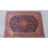 Persian rug, red field with allover foliate pattern, ivory spandrels and flowerhead borders, 154 x