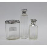 Three early 20th century silver topped glass jars / bottles, tallest 14cm (3)