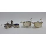 George V silver three piece condiment set, Birmingham 1932, complete with blue glass liners,