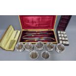 Cased set of twelve Epns napkin rings together with a set of twelve small coasters with turned