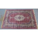 Kashmiri carpet, red ground with ivory medallion and allover floral pattern, 300 x 196cm