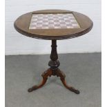 Mahogany games table, circular top inset with a chess board depicting castle ruins, tripod legs