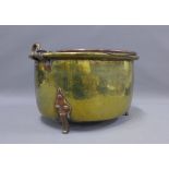 Arts & Crafts copper and brass pan / planter, with a swing handle and raised on three feet, 44cm