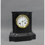 Mantle clock with a French brass movement striking on a gong, housed in a painted black case, 22cm
