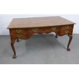 Walnut library / writing table with a leather skivver and five frieze drawers on shell carved
