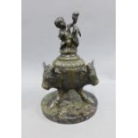 Victorian bronze inkwell with a detachable cover surmounted by a cherub, on a circular hardstone