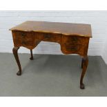 Walnut dressing table with serpentine top over five drawers,on carved cabriole legs with claw and